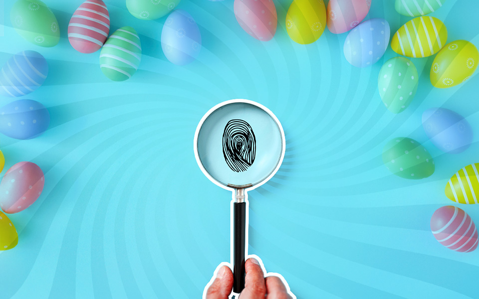 Svijetloplava pozadina na kojoj su raznobojna uskršnja jaja, a u sredini vizuala je otisak prsta vidljiv kroz povećalo kojeg drži ruka.